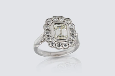 18ct White Gold 1.50ct Emerald and 0.65ct Diamond Rubover Halo Ring Size K